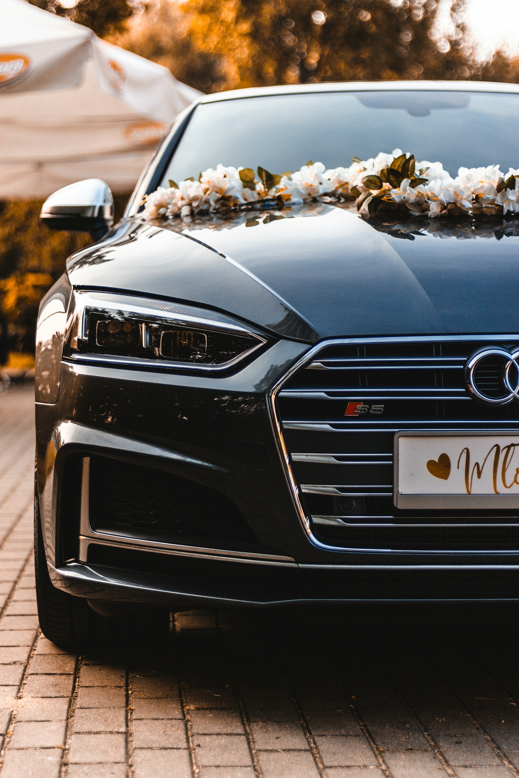 Black luxury car parked outside a venue